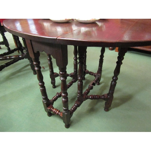 4105 - An 18th Century country oak gate leg table of small proportions the oval top rising leaves on turned... 