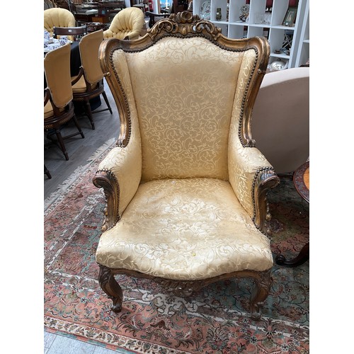 4125 - A pair of French lady's and gent's fireside armchairs, gilded carved wooden frames with scrolls and ... 