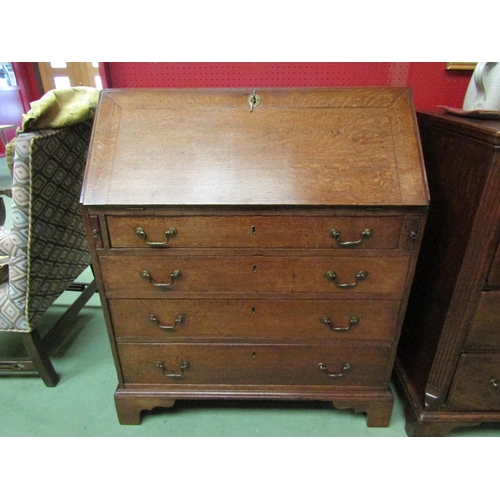 4136 - A George III country oak bureau with fitted interior over four graduating long drawers on bracket fe... 