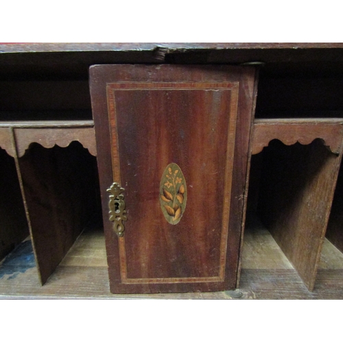 4136 - A George III country oak bureau with fitted interior over four graduating long drawers on bracket fe... 