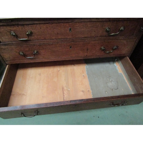 4136 - A George III country oak bureau with fitted interior over four graduating long drawers on bracket fe... 