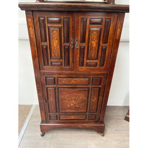 4141 - A Victorian rosewood mirror-back music cabinet, marquetry panels of musical instruments, twin door o... 