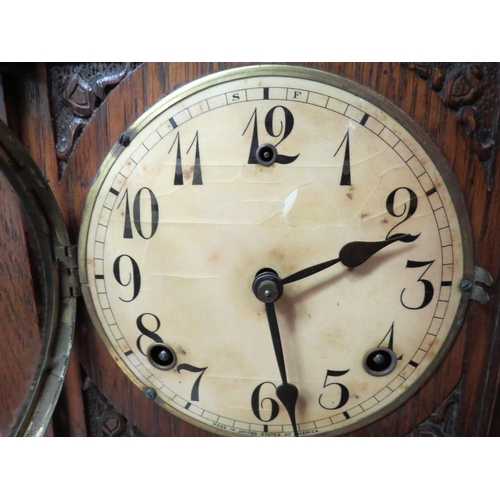 4160 - An early 20th Century American oak cased mantel clock of architectural form, with key and pendulum