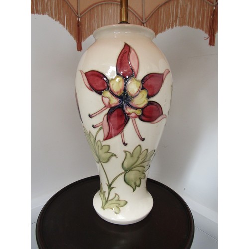 4215 - A Moorcroft table lamp, cream ground with aquilegia design, the base standing approximately 32.5cm t... 