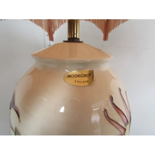 4215 - A Moorcroft table lamp, cream ground with aquilegia design, the base standing approximately 32.5cm t... 