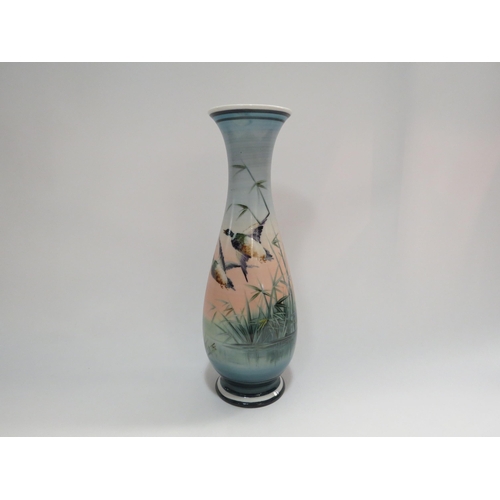 4282 - A hand painted glass vase depicting ducks in flight, 27cm tall