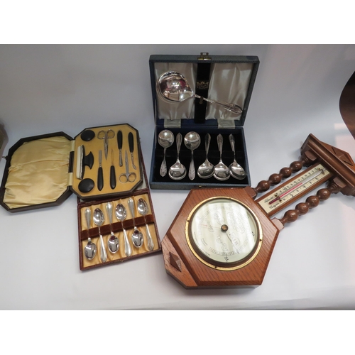 4318 - An oak barometer and a collection of cased cutlery and manicure set