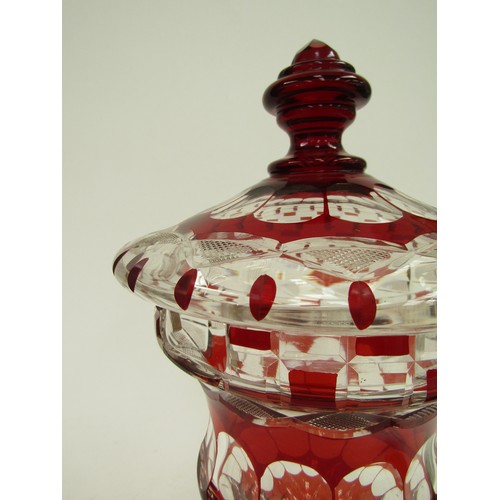 4326 - A ruby and clear glass pedestal jar and cover with ladle, 30cm tall    (R) £150