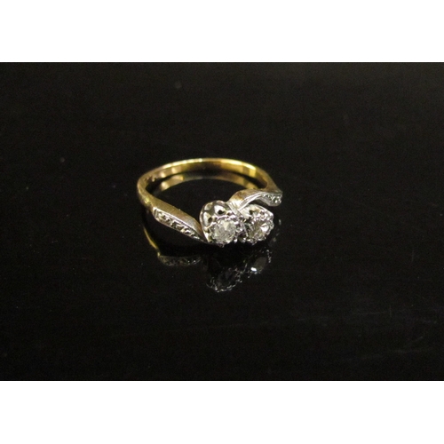 4406 - A diamond crossover ring with diamond set shoulders stamped 18ct/plat. Size K/L, 2.6g