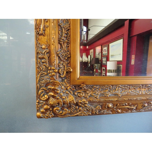 4025 - A large gilt framed rectangular bevel edged wall mirror, decorative frame, 87cm x 117cm total