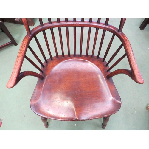 4029 - An oak high stick-back Windsor armchair the saddle seat on turned legs joined by a crinoline stretch... 