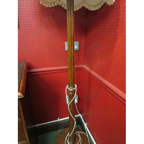 4047 - An oak column form standard lamp with shade