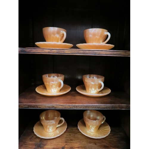 4058 - A quantity of Anchor Hocking U.S.A. orange lustre table wares including cups and saucers, plates and... 