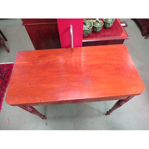 4081 - An early Victorian mahogany fold-over top side table on fine ring-turned and tapering leg supports  ... 