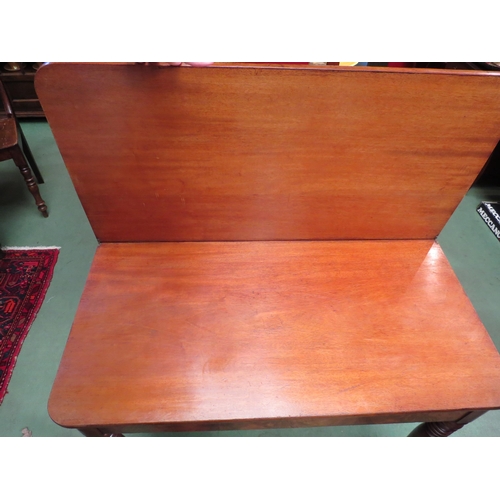 4081 - An early Victorian mahogany fold-over top side table on fine ring-turned and tapering leg supports  ... 