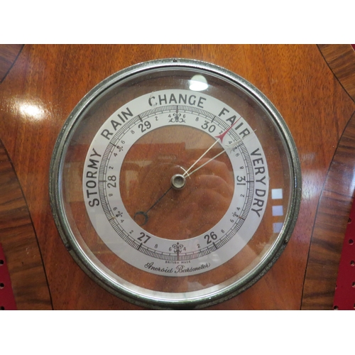 4115 - A 1930's mahogany and walnut Aneroid Barometer with presentation plaque and a German cuckoo clock (2... 