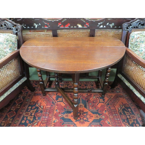 4129 - An 18th Century oak country cottage gate-leg table the rising leaves oval top with single end cutler... 