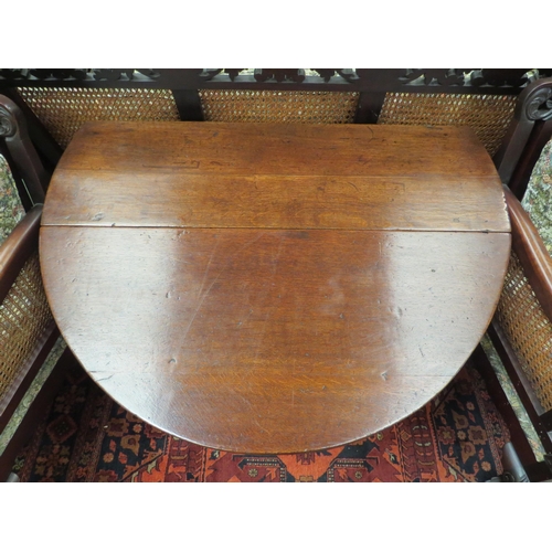 4129 - An 18th Century oak country cottage gate-leg table the rising leaves oval top with single end cutler... 