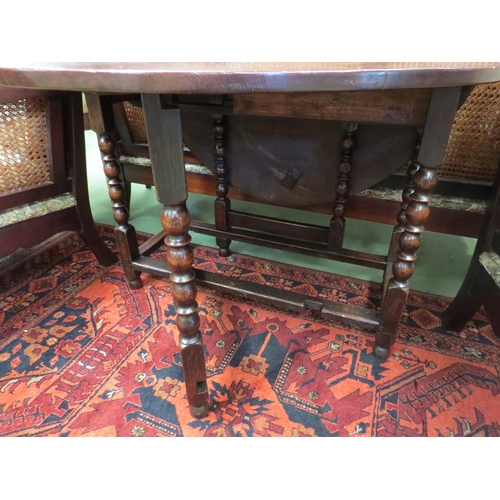 4129 - An 18th Century oak country cottage gate-leg table the rising leaves oval top with single end cutler... 