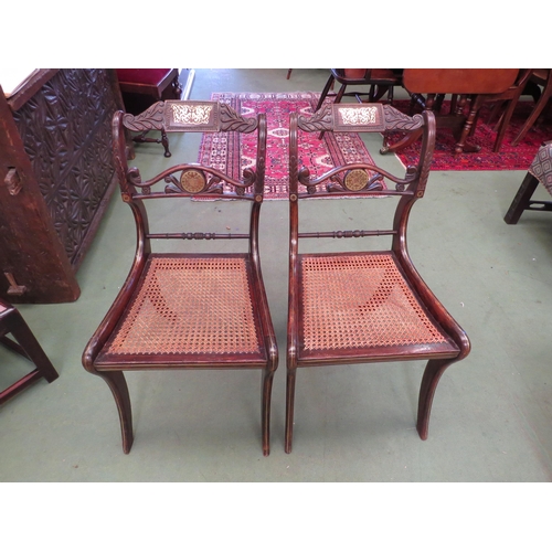 4130 - A pair of Regency hall chairs, simulated rosewood with brass inlay, carved back rest, cane seats on ... 