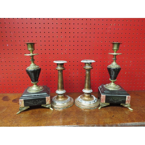 4135 - A pair of clock garniture black slate and brass candlesticks, together with a pair of copper example... 