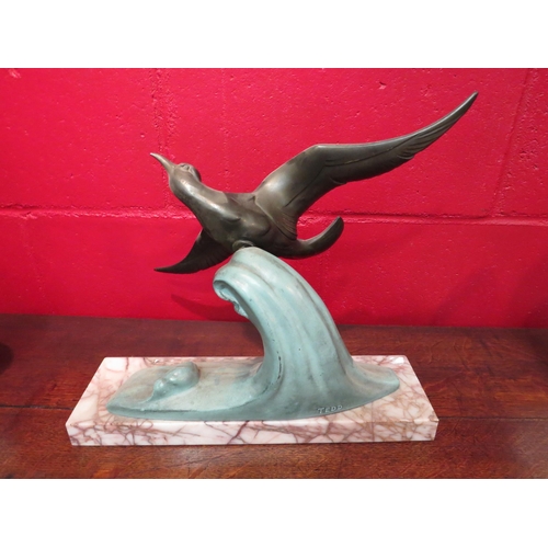 4145 - An Art Deco spelter figure of bird riding a wave, marble base, 34cm high x 38cm wide