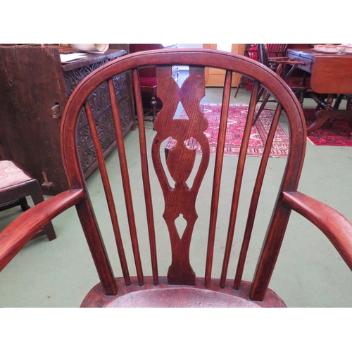 4179 - A 19th Century elm and ash hoop-back Windsor armchair with pierced shield central splat over a saddl... 