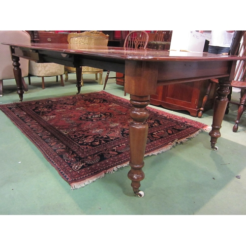 4185 - A Victorian style mahogany round cornered top extending dining table having two extra leaves and bra... 