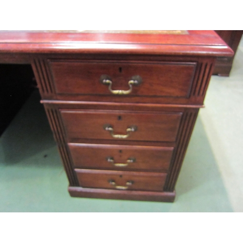 4197 - A Georgian revival mahogany twin pedestal desk, the tooled leather insert over eight drawers with br... 