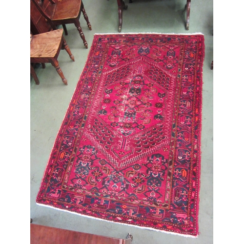 4485 - A red and blue ground hand woven geometric design wool rug (worn) 212cm x 134cm    (R) £35