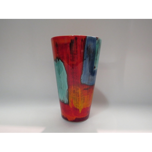 4267 - A Poole Pottery vase in orange, red and blue, 24cm tall