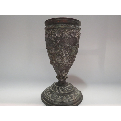 4298 - An ornate cast metal vase with floral detailing, 25cm tall