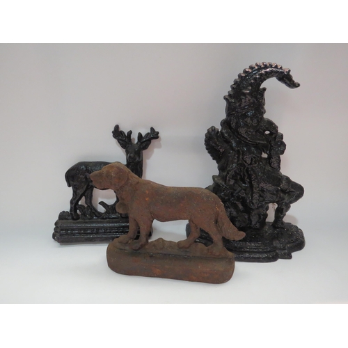 4311 - Three cast iron doorstops including Punch and dog