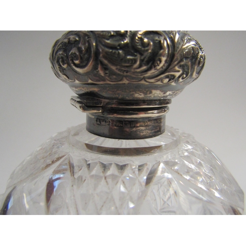 4358 - A silver topped glass scent bottle of globular form, 12cm tall