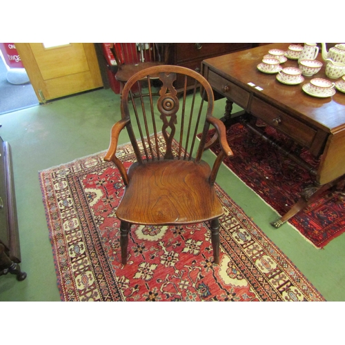 4090 - A 19th Century elm and yew stick-back Windsor armchair with roundel central splat over a saddle seat... 