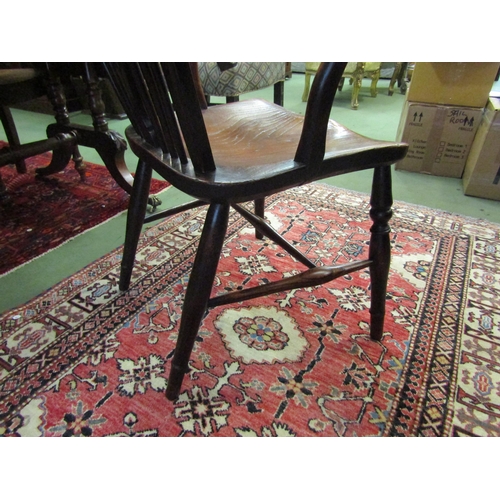 4090 - A 19th Century elm and yew stick-back Windsor armchair with roundel central splat over a saddle seat... 