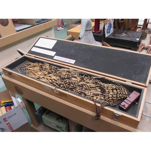 9147 - A wooden cased Maori skirt