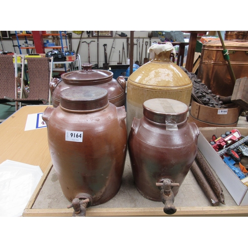 9164 - A lidded salt glazed crock, two salt glazed pots with taps and large glazed flagon