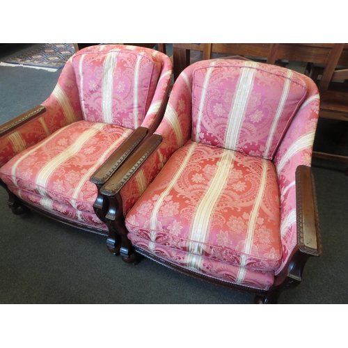 1012 - A pair of Arts & Crafts mahogany Bergere armchairs with carved armrest and feather filled cushions, ... 