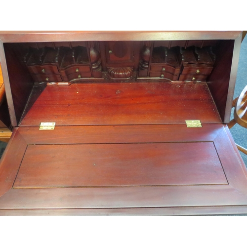 1029 - A Georgian style mahogany bureau, the drop-flap revealing a fitted interior, two short over three lo... 