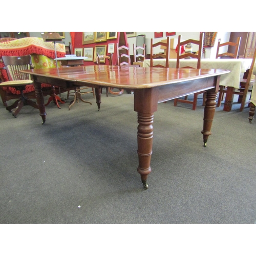 1144 - A mahogany extending dining table with two additional leaves, turned legs on castors, 72cm high x 20... 