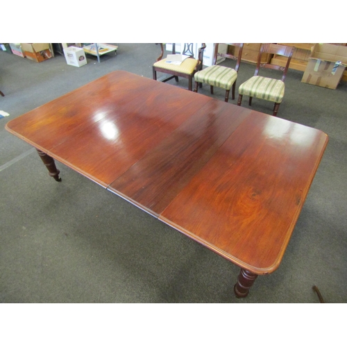 1144 - A mahogany extending dining table with two additional leaves, turned legs on castors, 72cm high x 20... 