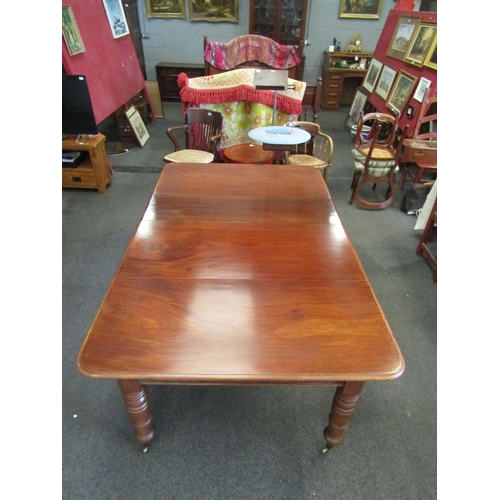 1144 - A mahogany extending dining table with two additional leaves, turned legs on castors, 72cm high x 20... 