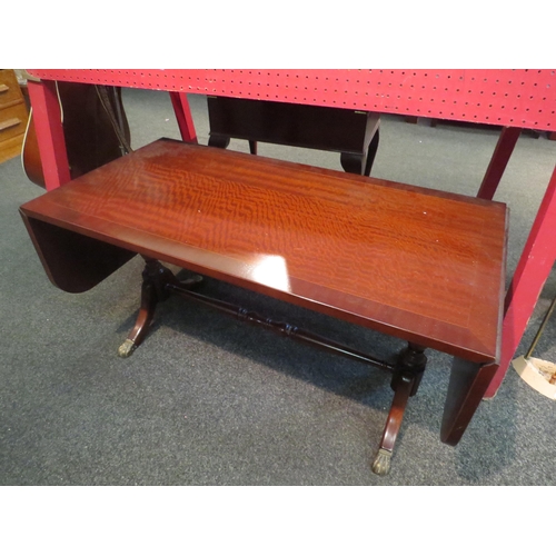 1165 - A Regency style drop-leaf coffee table with paw feet