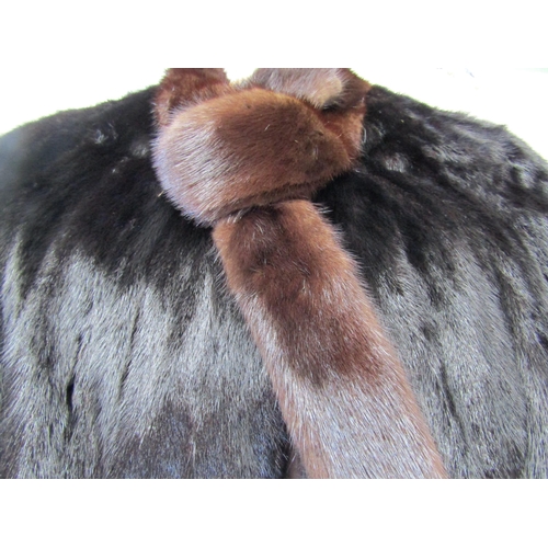 1166 - A black mink coat with a brown mink tie neck collar