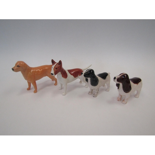 1475 - Four Beswick small dogs: Labrador (golden) model no. 1956, Cocker Spaniel black and white, model no.... 