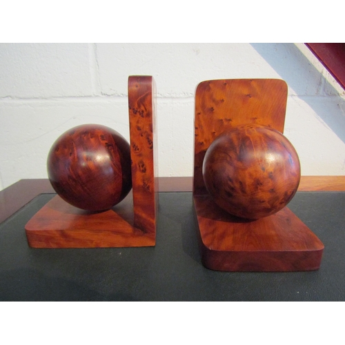 1006 - A pair of modern burr walnut spherical design book-ends, 15.5cm high