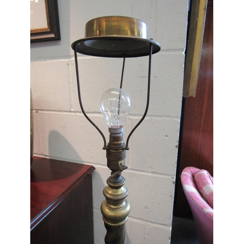 1021 - An early 20th Century brass standard lamp with rope twist support