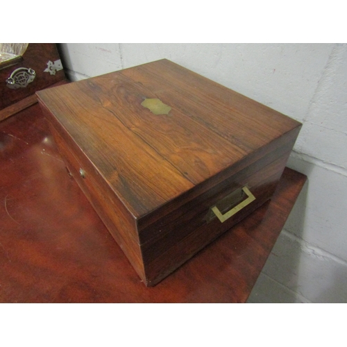 1043 - A Victorian rosewood writing box, campaign style brass inset handles, fitted interior, the lid with ... 