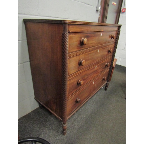 1046 - A 19th Century mahogany chest of four long drawers, satinwood stringing, turned bun handles, bone es... 